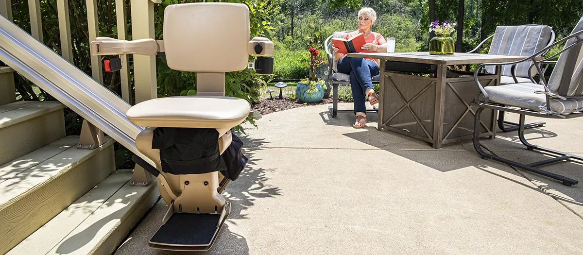 Bruno Elite straight outdoor stair lift parked at a top of staircase outside