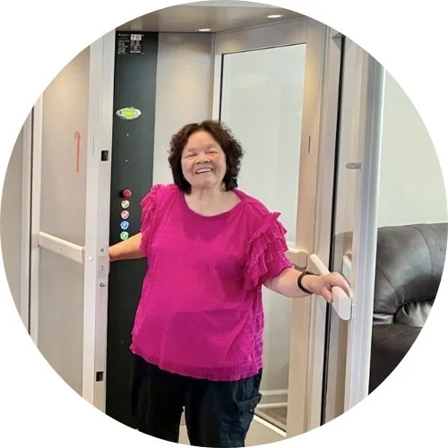 a woman standing in a home elevator