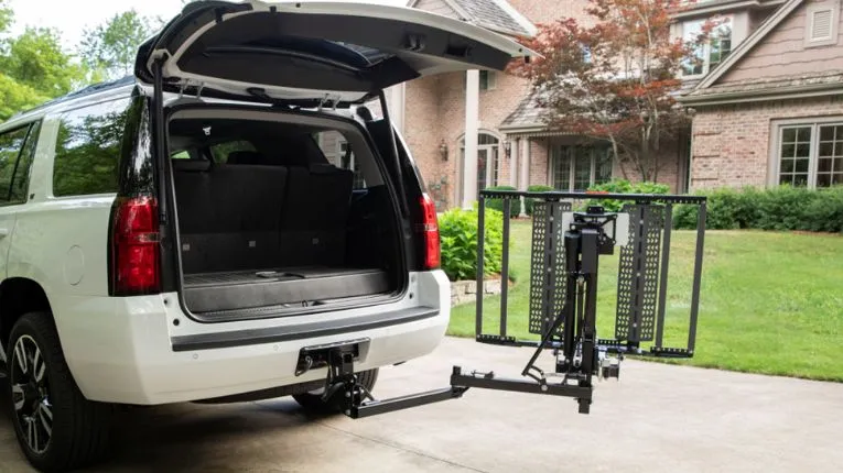 out sider scooter lift on the back of an suv with the hatch open