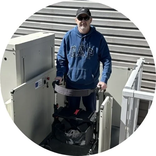 a man riding a platform lift