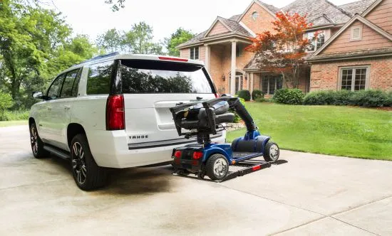 scooter loaded up behind a white suv