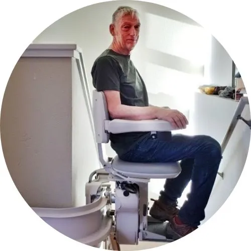 a man riding an indoor stair lift