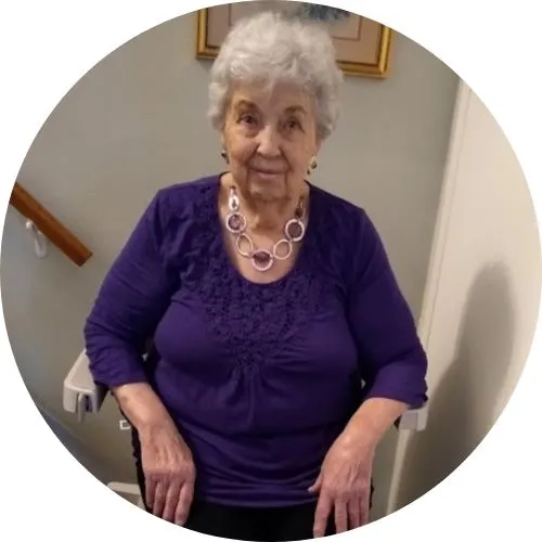 a woman riding an indoor stair lift