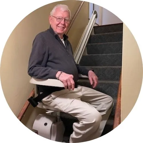 a man riding an indoor stair lift