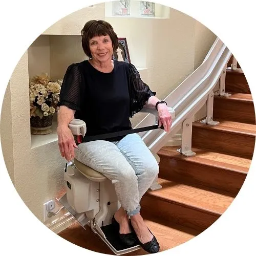a woman riding an indoor stair lift