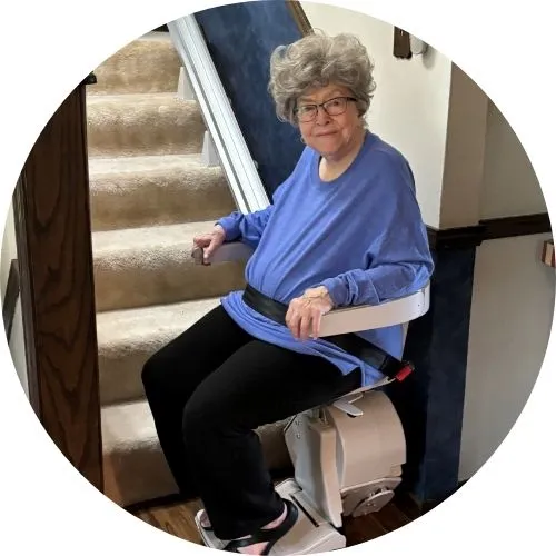 a woman riding an indoor stair lift
