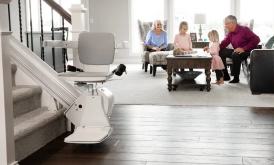 an indoor stair lift with a family playing in living room behind it