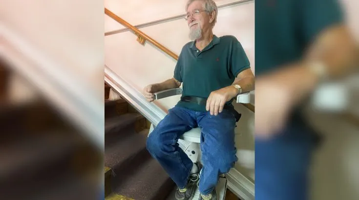 a man riding an indoor stair lift