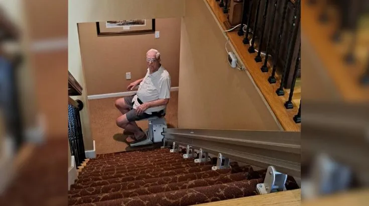 a man riding an indoor stair lift